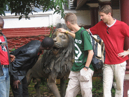 Tim and his friends with a lion statue at the Chieftain