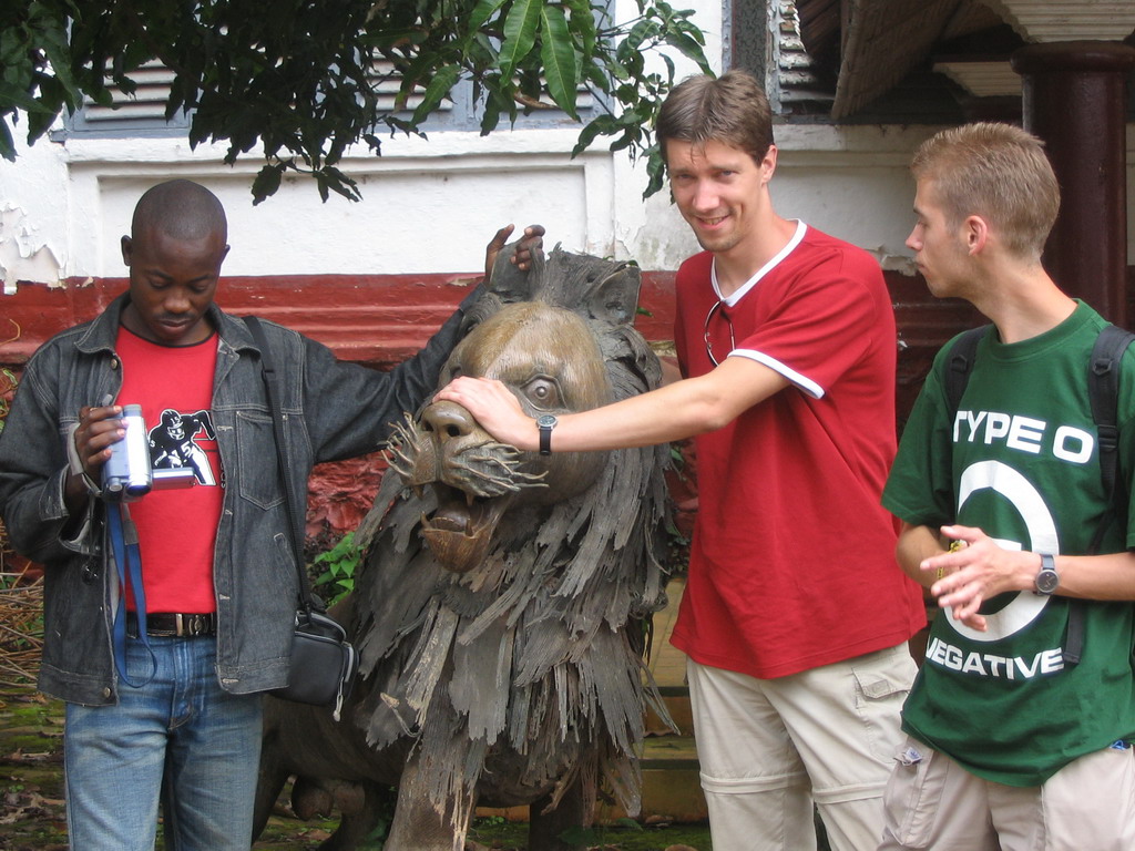 Tim and his friends with a lion statue at the Chieftain