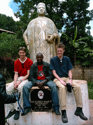 Tim and his friends at a statue in front of the Bandjoun Palace