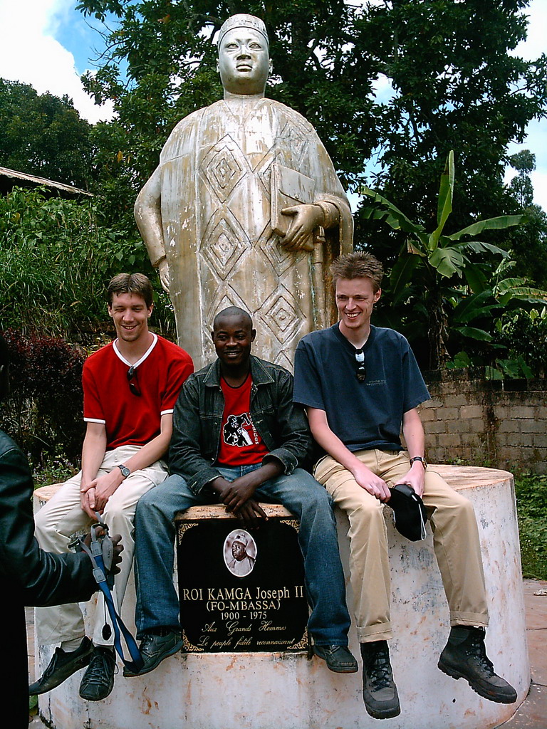 Tim and his friends at a statue in front of the Bandjoun Palace