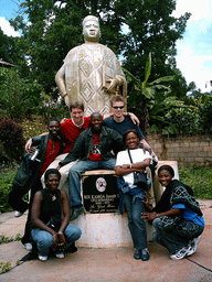 Tim and his friends at a statue in front of the Bandjoun Palace