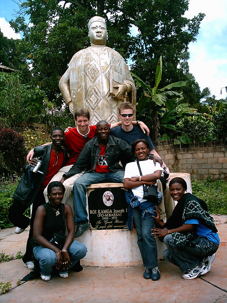 Tim and his friends at a statue in front of the Bandjoun Palace