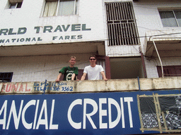 Tim and his friend at a balcony at a street at the city center