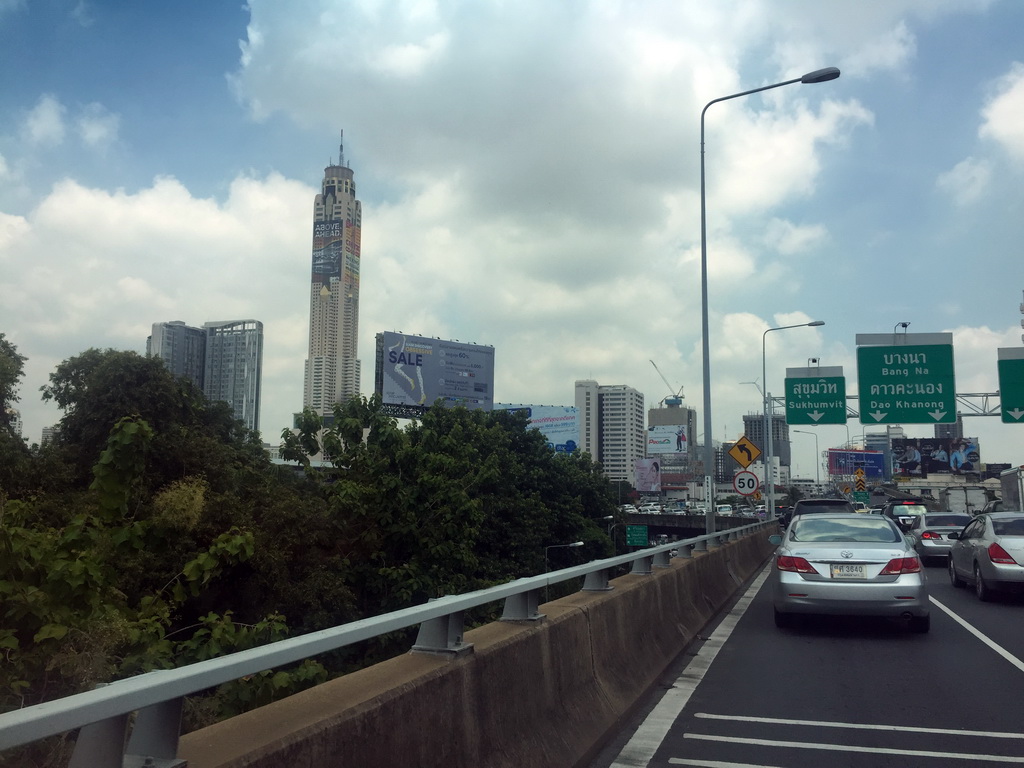 Trees and skyscrapers in the city center, viewed from the taxi on Chaturathid Road