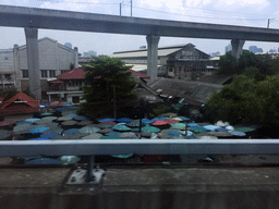 Market at the Nikhom Makkasan Road, viewed from the taxi on Chaturathid Road