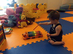 Max playing with a xylophone in the Play Room of the Grande Centre Point Hotel Ratchadamri Bangkok