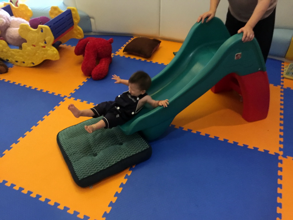 Miaomiao and Max on a slide in the Play Room of the Grande Centre Point Hotel Ratchadamri Bangkok