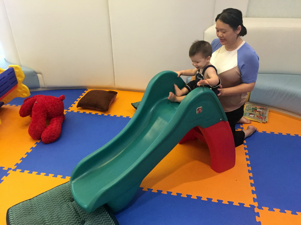 Miaomiao and Max on a slide in the Play Room of the Grande Centre Point Hotel Ratchadamri Bangkok