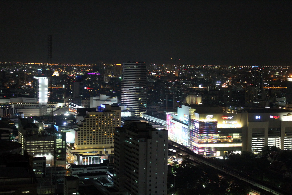 The Siam Paragon shopping mall, the Wat Saket temple and skyscrapers in the Central Business District, viewed from our room at the Grande Centre Point Hotel Ratchadamri Bangkok, by night