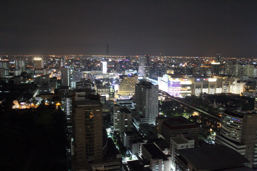 The Royal Bangkok Sports Club golf course, the Siam Paragon shopping mall, the Wat Pathumwanaram Ratchaworawihan temple, the Wat Saket temple and skyscrapers in the Central Business District, viewed from our room at the Grande Centre Point Hotel Ratchadamri Bangkok, by night