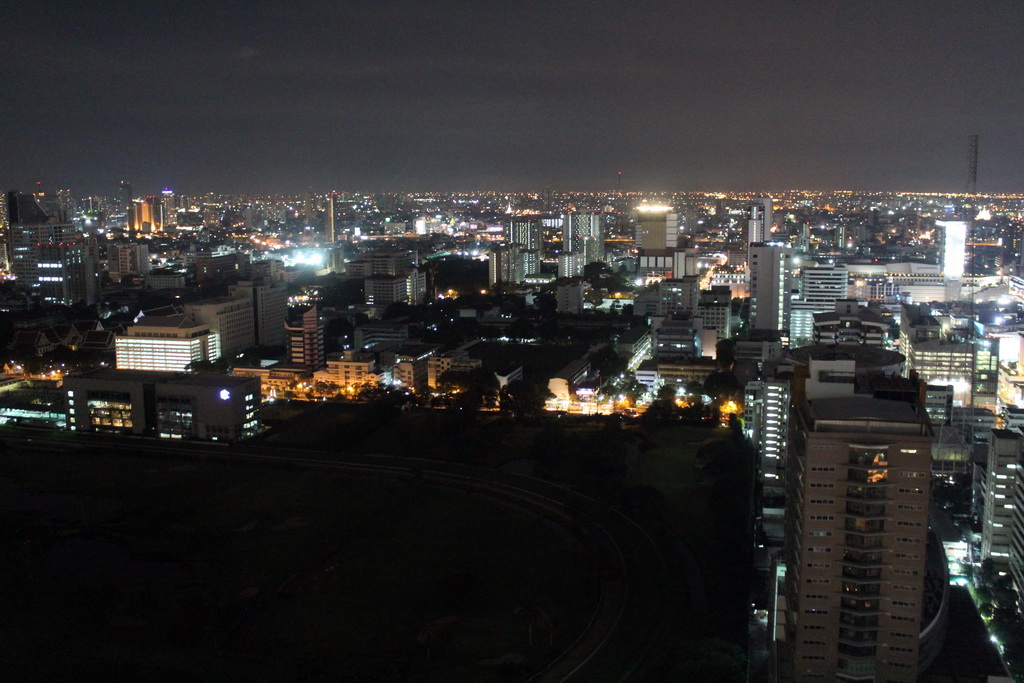 The Royal Bangkok Sports Club golf course, the Wat Saket temple and skyscrapers in the city center, viewed from our room at the Grande Centre Point Hotel Ratchadamri Bangkok, by night