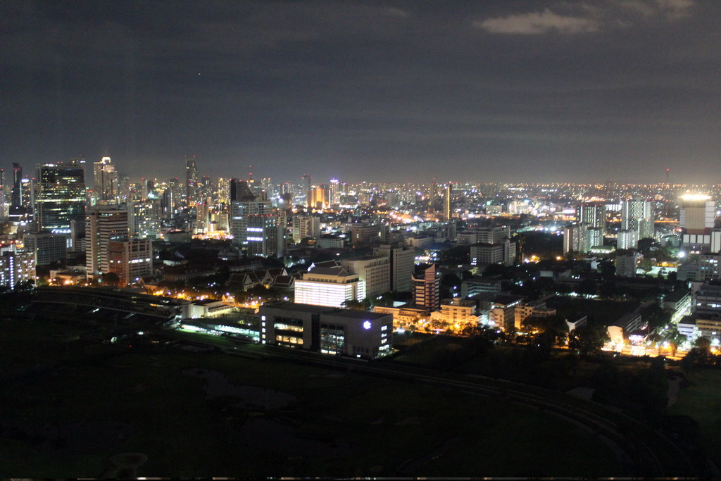 The Royal Bangkok Sports Club golf course, Chulalongkorn University, the State Tower and other skyscrapers in the city center, viewed from our room at the Grande Centre Point Hotel Ratchadamri Bangkok, by night