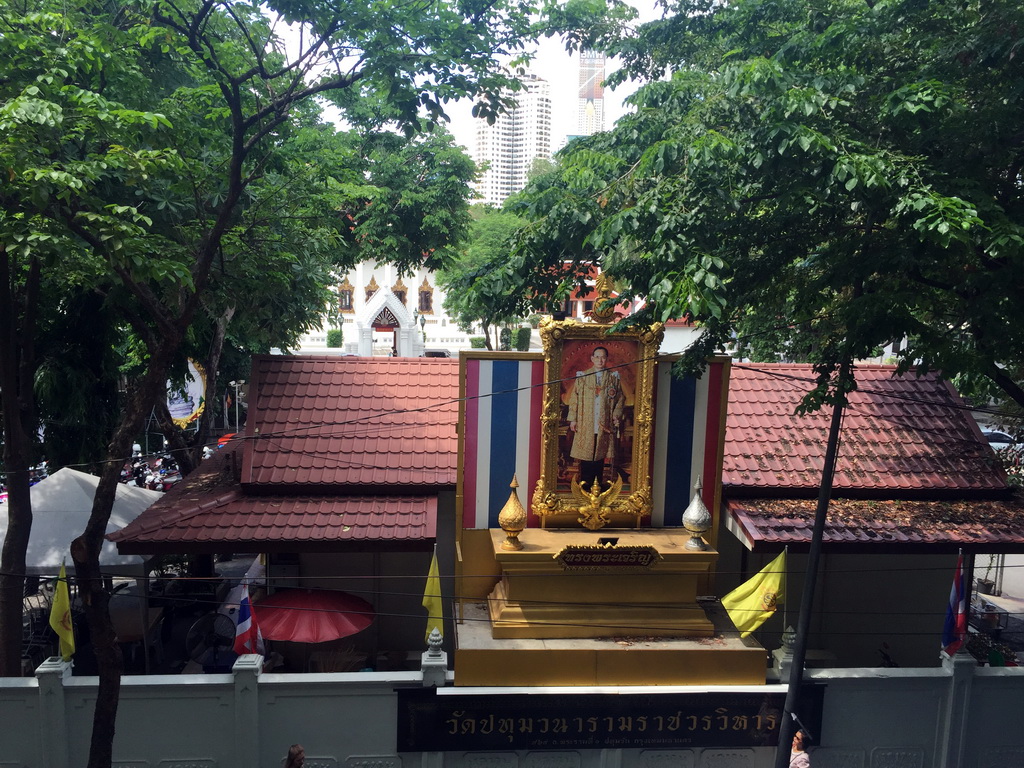 Front of the Wat Pathumwanaram Ratchaworawihan temple at Rama I Road with a portrait of King Rama IX, viewed from the skywalk