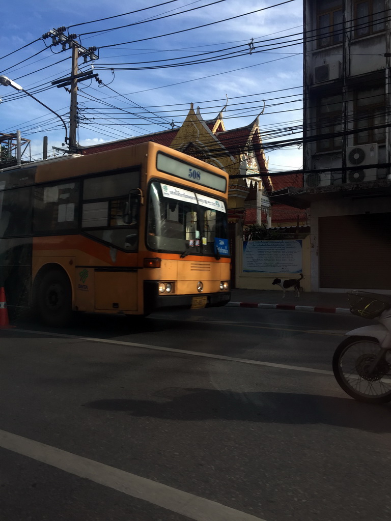 Bus and the front of the Wat Chai Mongkol temple at Rama I Road, viewed from the taxi