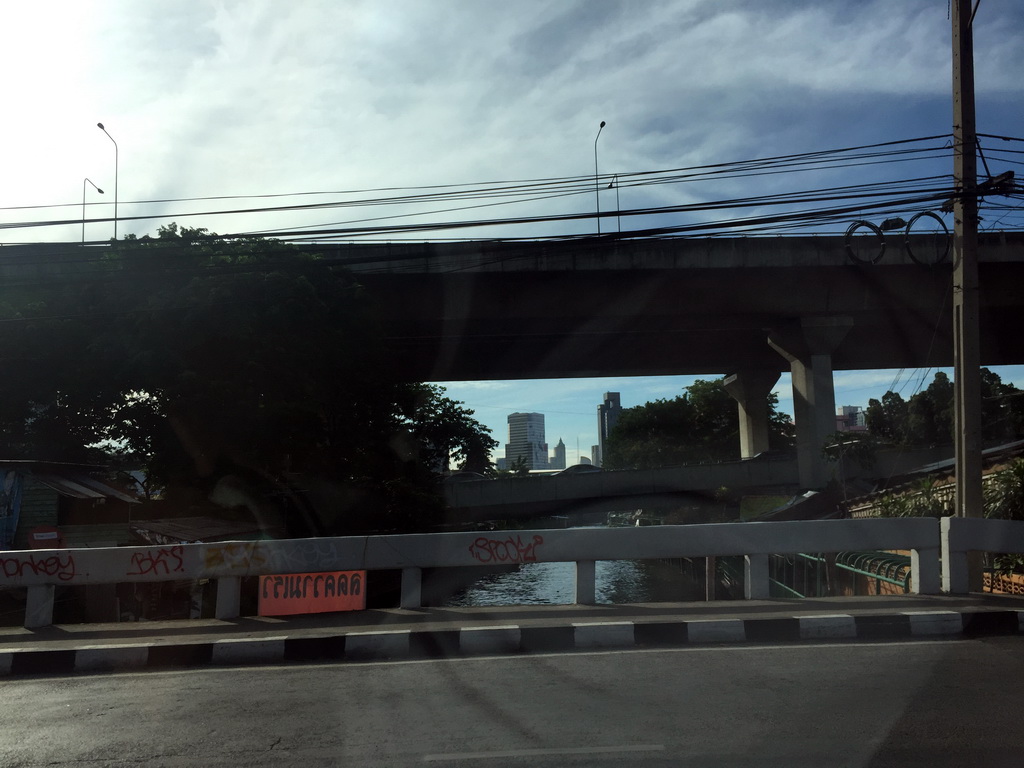 The Khlong Saen Saep canal and skyscrapers in the city center, viewed from the taxi at Rama VI Road