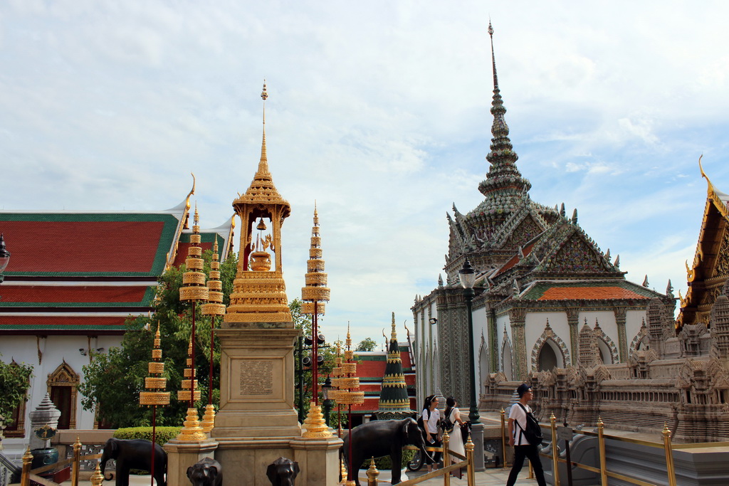 Column with elephants in front of the Phra Wiharn Yod hall and the Hor Phra Naga hall at the Temple of the Emerald Buddha at the Grand Palace