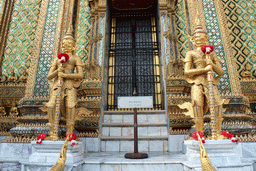 Yaksha statues in front of the Phra Mondop hall at the Temple of the Emerald Buddha at the Grand Palace