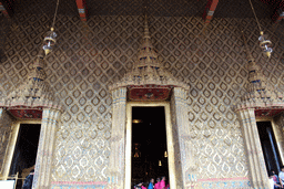 East gates and the Emerald Buddha statue in the Chapel of the Emerald Buddha at the Temple of the Emerald Buddha at the Grand Palace