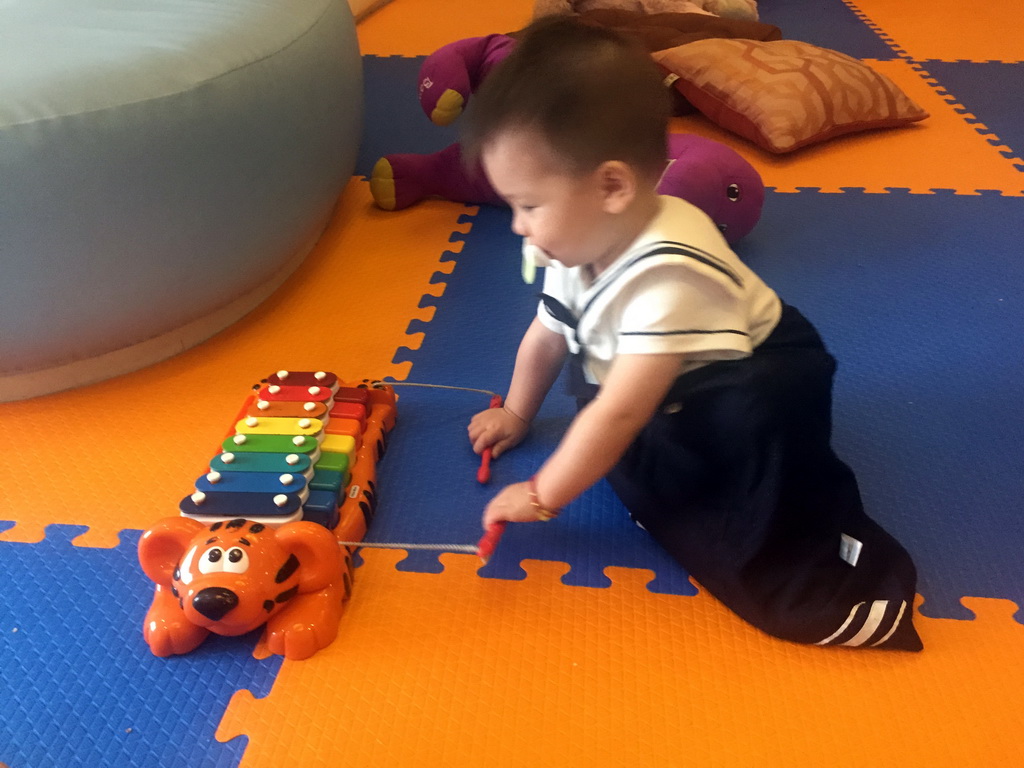 Max playing with a xylophone in the Play Room of the Grande Centre Point Hotel Ratchadamri Bangkok