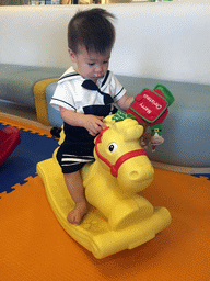 Max on a rocking horse in the Play Room of the Grande Centre Point Hotel Ratchadamri Bangkok