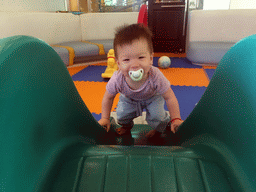 Max on a slide in the Play Room of the Grande Centre Point Hotel Ratchadamri Bangkok