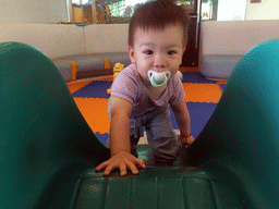 Max on a slide in the Play Room of the Grande Centre Point Hotel Ratchadamri Bangkok