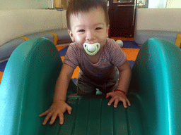 Max on a slide in the Play Room of the Grande Centre Point Hotel Ratchadamri Bangkok