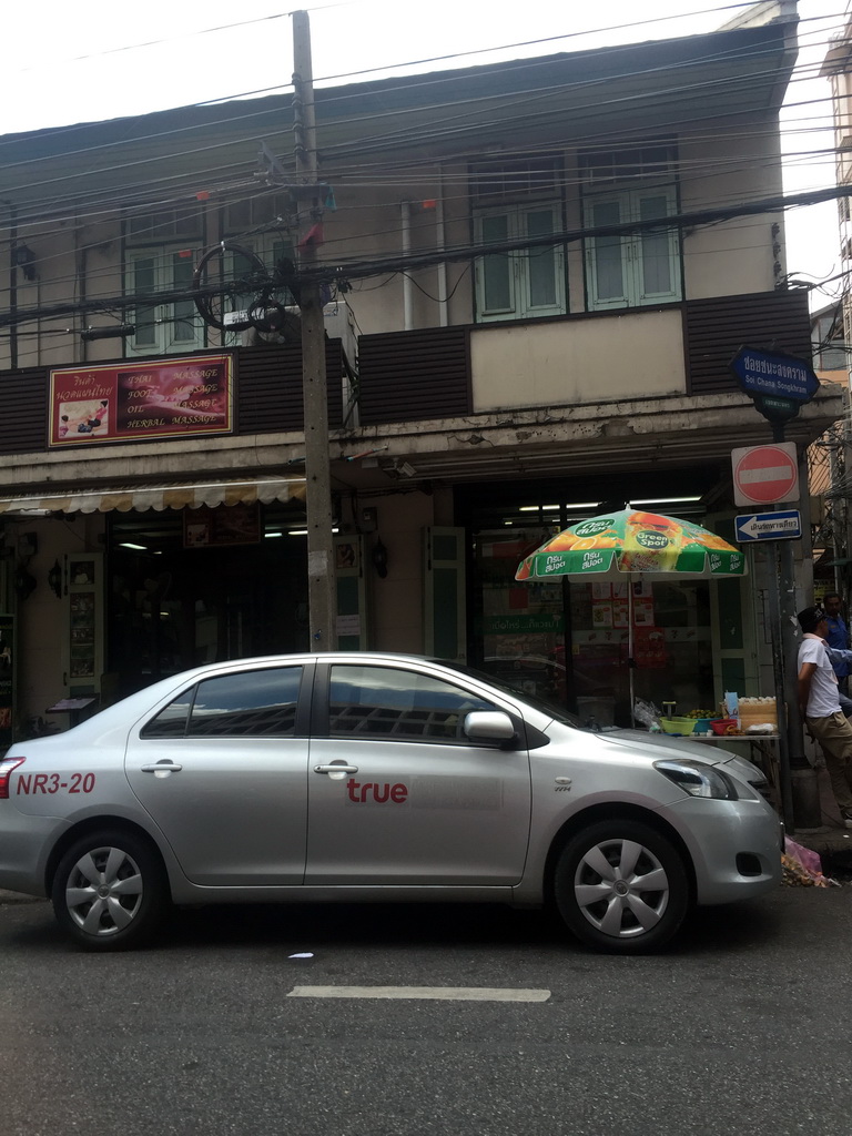Front of a massage saloon and a shop at Phra Athit Road, viewed from the taxi