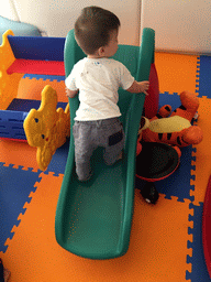 Max on a slide in the Play Room of the Grande Centre Point Hotel Ratchadamri Bangkok