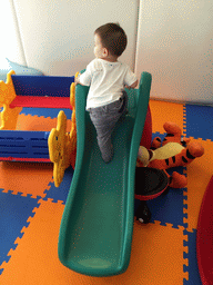 Max on a slide in the Play Room of the Grande Centre Point Hotel Ratchadamri Bangkok