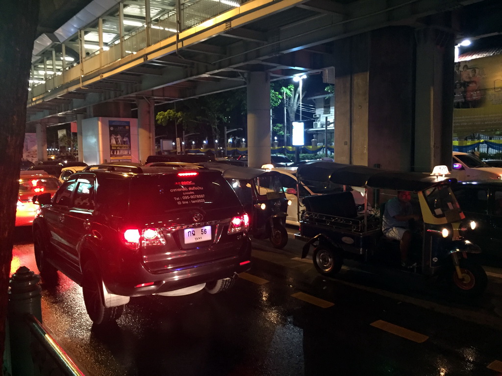 Rickshaws, cars and skywalk at Rama I Road, by night