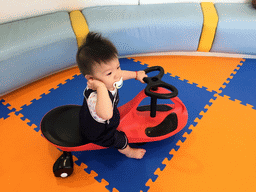 Max on a bike in the Play Room of the Grande Centre Point Hotel Ratchadamri Bangkok