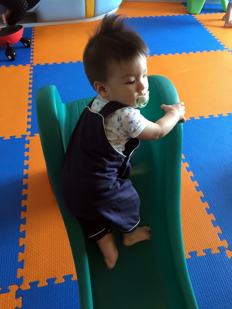 Max on a slide in the Play Room of the Grande Centre Point Hotel Ratchadamri Bangkok