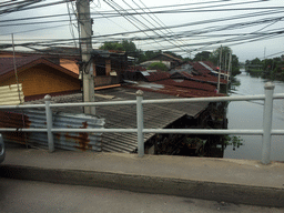 Bridge and buildings at the Prawet Burirom river, viewed from the taxi