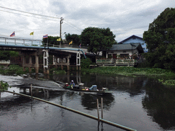 Bridge, boat and building at the Prawet Burirom river, viewed from the Wat Sangkha Racha temple complex