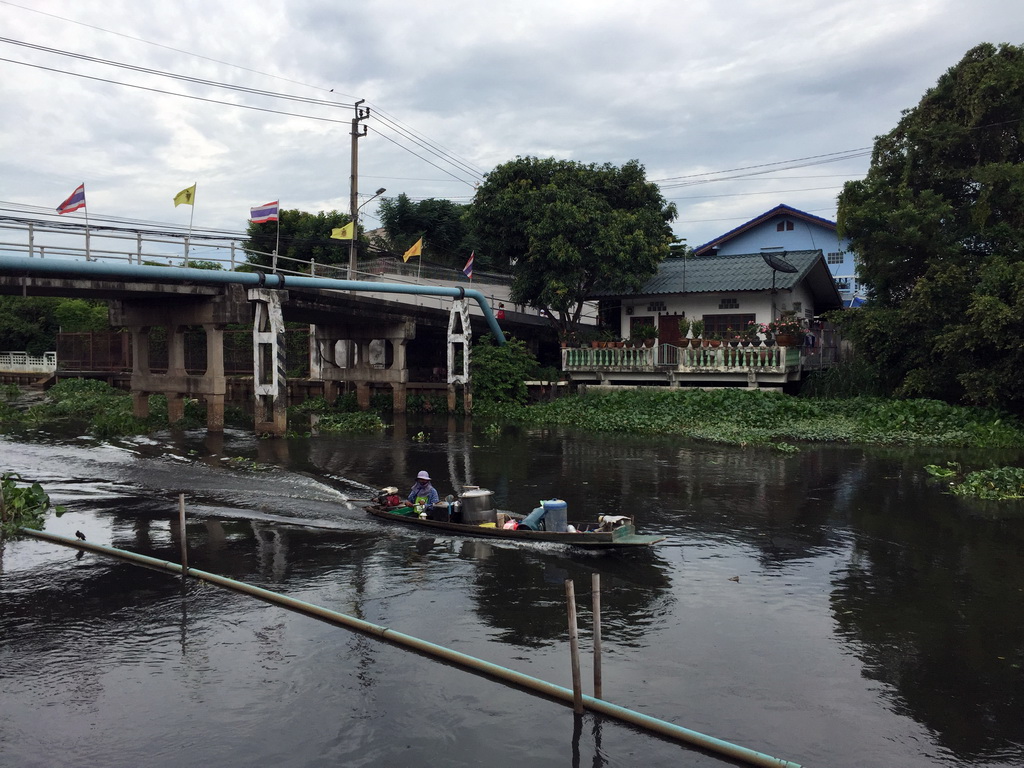 Bridge, boat and building at the Prawet Burirom river, viewed from the Wat Sangkha Racha temple complex