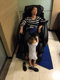 Miaomiao and Max in the massage chair in the business class lounge of China Airlines at Bangkok Suvarnabhumi Airport