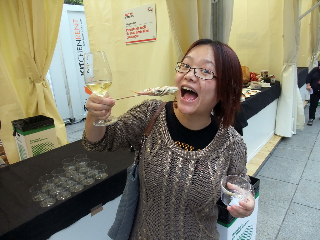 Miaomiao with food and wine at the `Mercat de Mercats` market at the Plaça Nova square