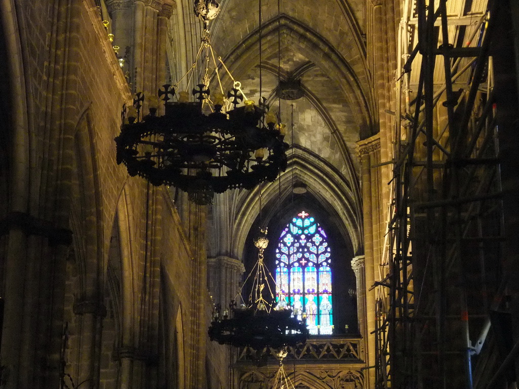 Chandeleers and stained glass window at the southwest nave of the Cathedral of Santa Eulalia