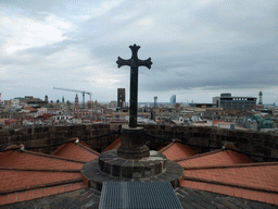 Cross at the roof of the Cathedral of Santa Eulalia, with a view on the region to the southeast, with the tower of the Basílica dels Sants Màrtirs Just i Pastor church, the W Barcelona building (Hotel Vela) and the Torre Jaume I tower