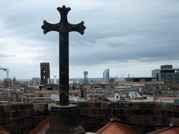 Cross at the roof of the Cathedral of Santa Eulalia, with a view on the region to the southeast, with the tower of the Basílica dels Sants Màrtirs Just i Pastor church and the W Barcelona building