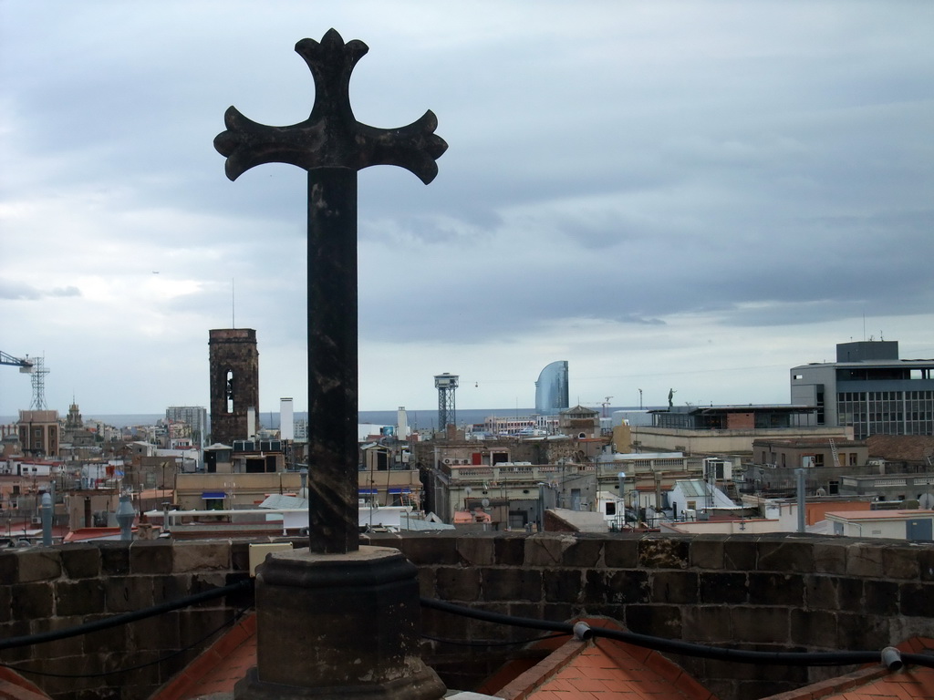 Cross at the roof of the Cathedral of Santa Eulalia, with a view on the region to the southeast, with the tower of the Basílica dels Sants Màrtirs Just i Pastor church and the W Barcelona building