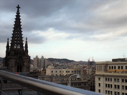 The roof and one of the towers of the Cathedral of Santa Eulalia, with a view on the Sagrada Família church and surroundings