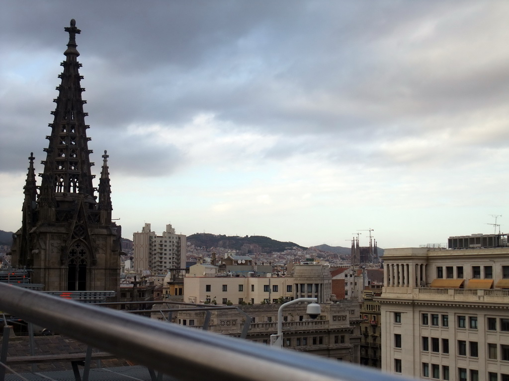 The roof and one of the towers of the Cathedral of Santa Eulalia, with a view on the Sagrada Família church and surroundings