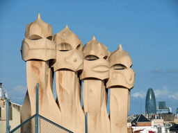 Ventilation towers at the roof of the La Pedrera building, with a view on the Torre Agbar tower