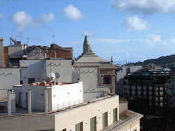 Statue on top of a building at the Passeig de Gràcia street, viewed from the roof of the La Pedrera building