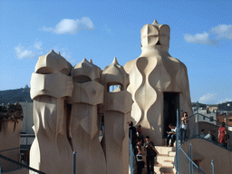 Chimney and ventilation towers at the roof of the La Pedrera building, with a view on Mount Tibidabo and the Temple Expiatori del Sagrat Cor church