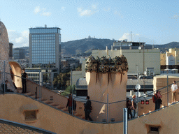 Ventilation towers at the roof of the La Pedrera building, with a view on Mount Tibidabo and the Temple Expiatori del Sagrat Cor church