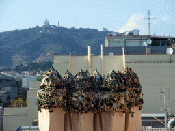 Ventilation towers at the roof of the La Pedrera building, with a view on Mount Tibidabo and the Temple Expiatori del Sagrat Cor church