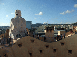 The roof of the La Pedrera building with chimneys and ventilation towers, with a view on Mount Tibidabo and the Temple Expiatori del Sagrat Cor church